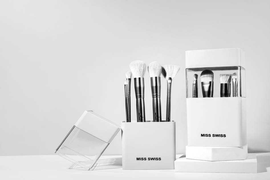Assortment of high-quality lip brushes on a marble surface with soft lighting